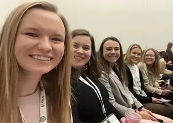 students take a selfie at a conference