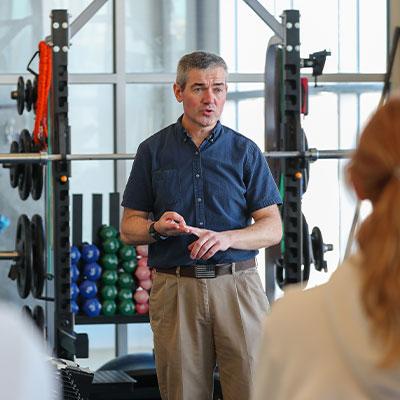 a faculty member teaches in a weight room