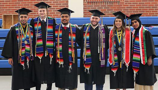 students pose for a photo at graduation